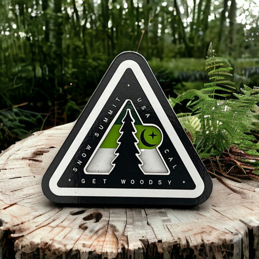 Woodsy logo on a magnet with green coloring
