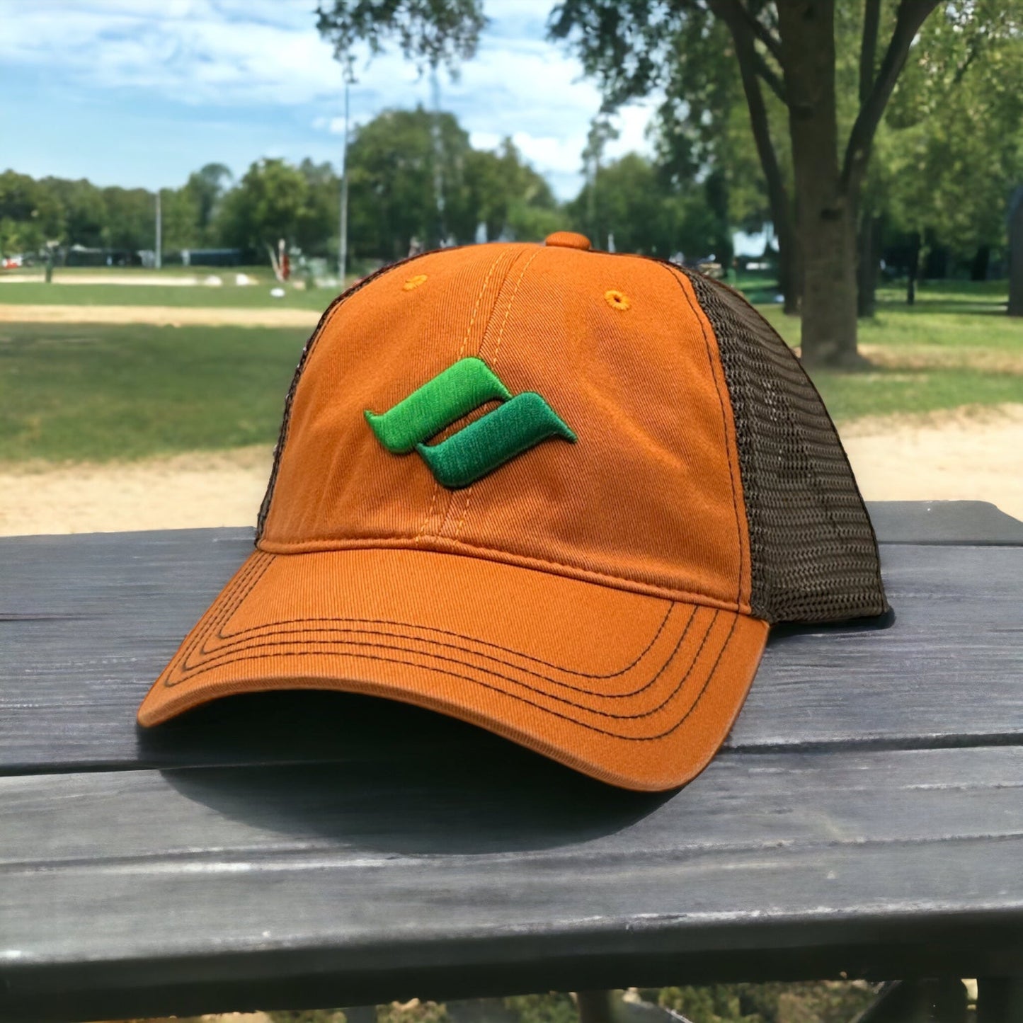 Orange hat with brown mesh back and green Snow Summit logo on the front