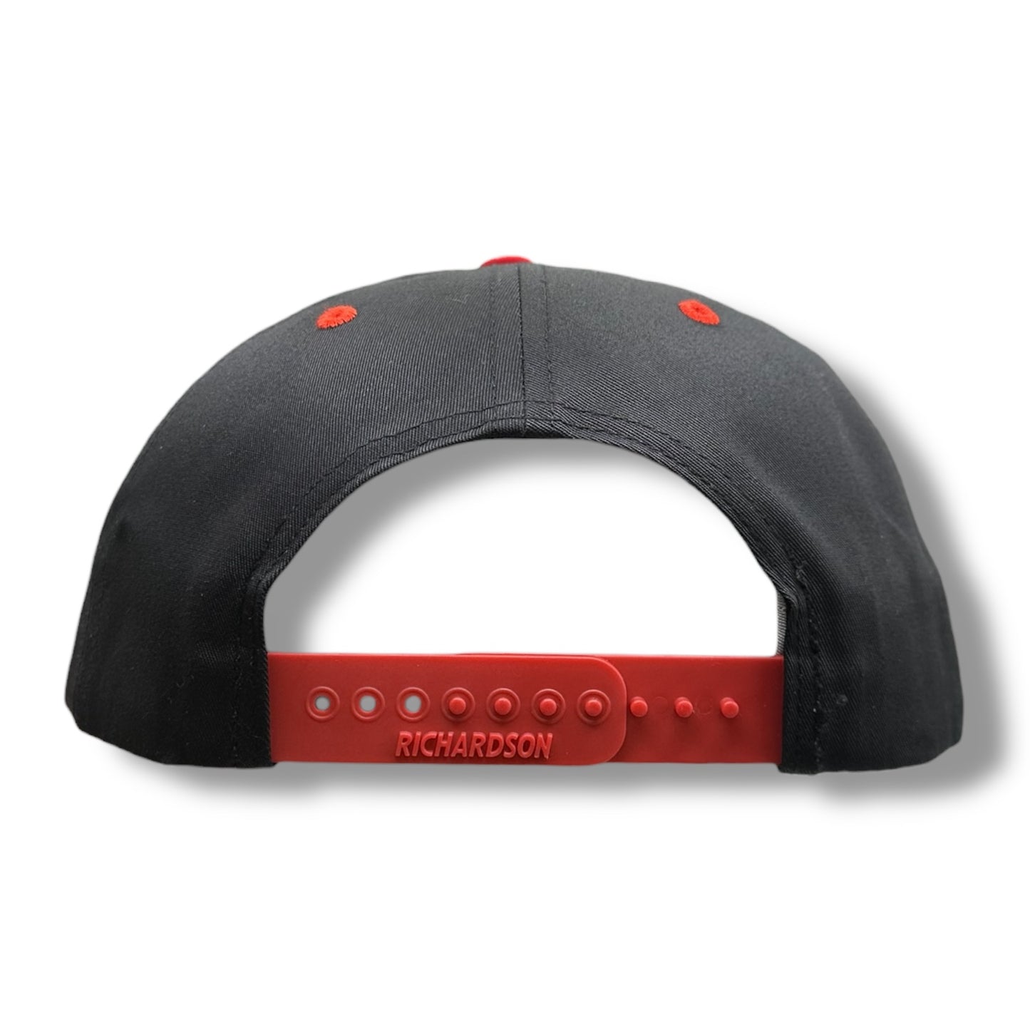 Backside of a black snapback Richardson hat, with red snapback clasp.