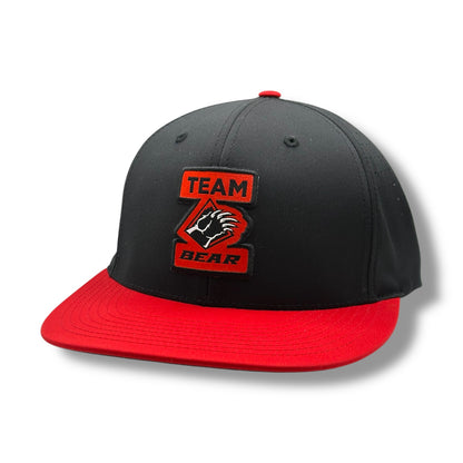 Flat bill black hat, with red brim and Team Bear logo with a bear claw.