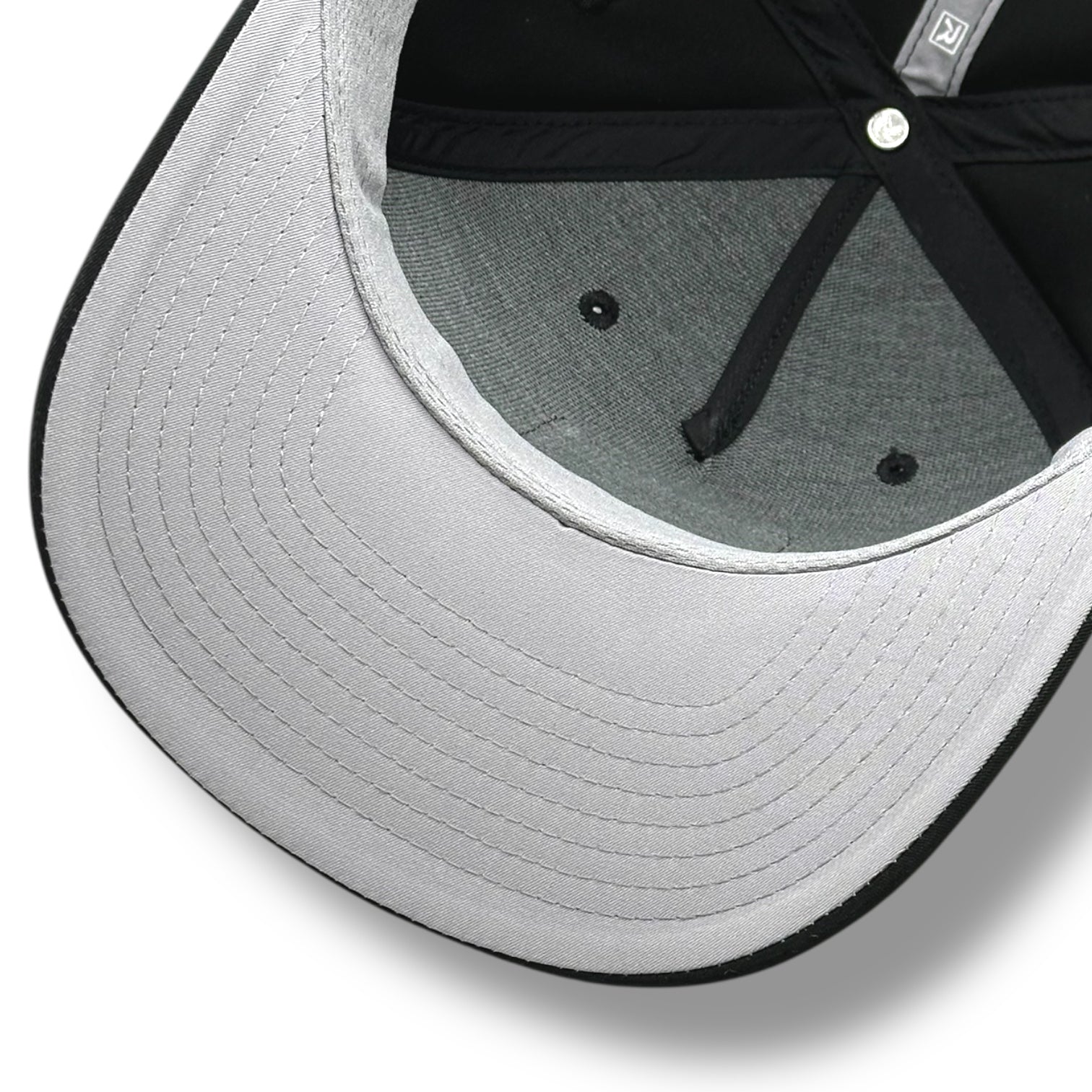 The gray under brim of a black hat, with black brim and gray with black lining.