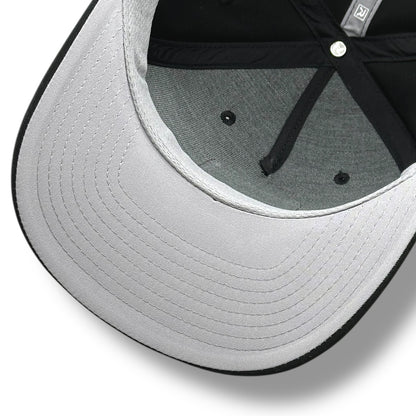The gray under brim of a black hat, with black brim and gray with black lining.