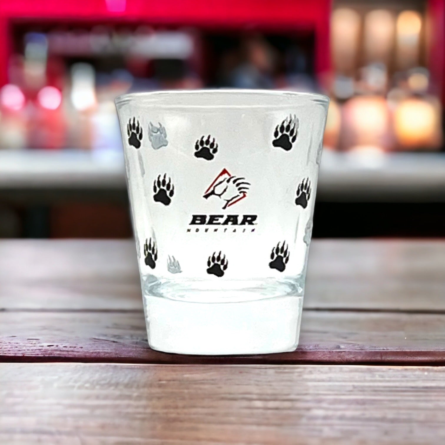 Shot glass with bear mountain logo printed around it